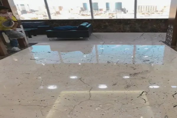 Before marble floor restoration in a Dubai hotel lobby showing a worn and dull marble surface