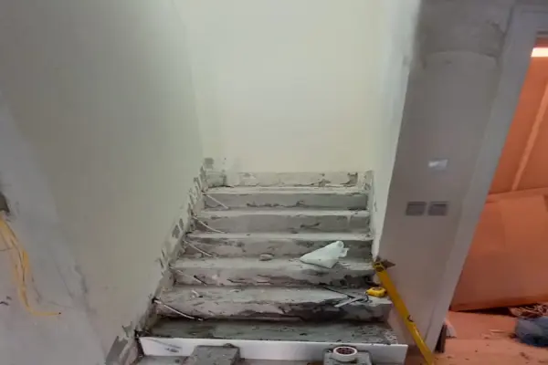 Before marble grinding service in Dubai Marina showing a damaged and uneven marble floor